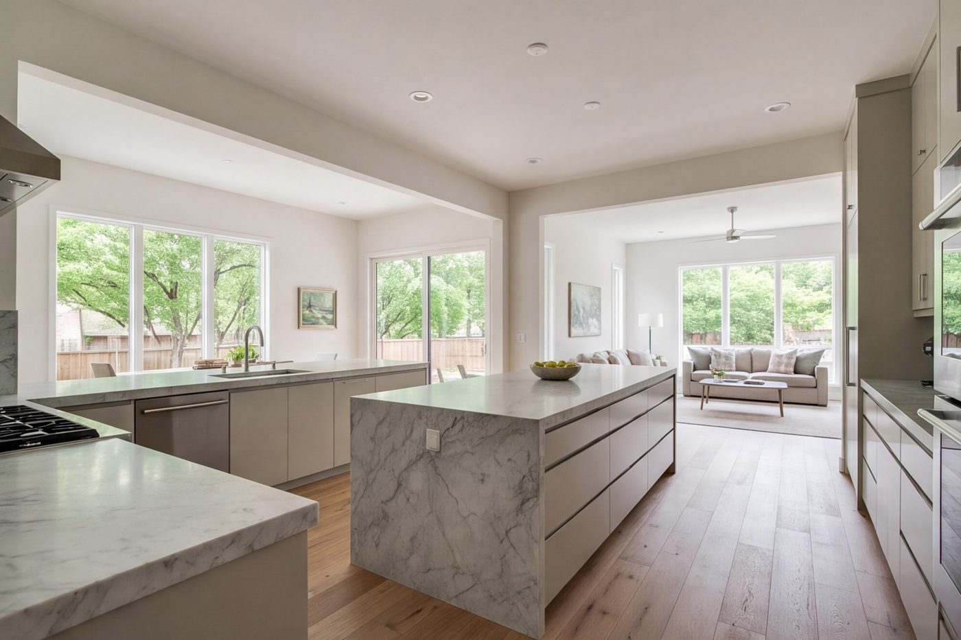 Stone-counter kitchen open to the living room in a bright remodeled home